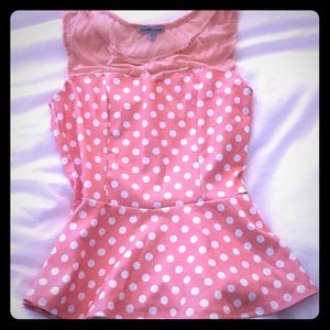 Coral polka dot peplum tank top.